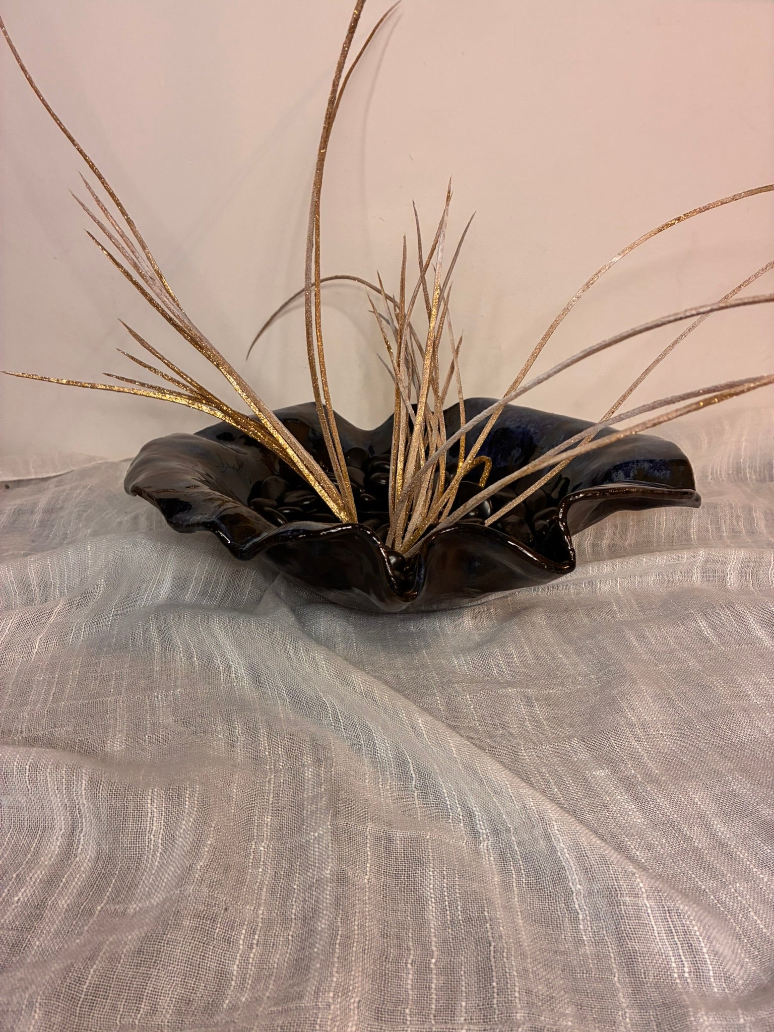 This handcrafted deep ceramic bowl features a wavy, organic form with subtle blue glaze accents, giving each piece a unique and artistic character. Perfectly versatile, it can be used as a decorative centerpiece or functionally for serving salads, fruits, or other dishes. Each bowl is individually made by hand, with natural variations in shape and glaze that celebrate its artisanal craftsmanship. Combining practicality with sculptural elegance, it brings both beauty and functionality to any table .