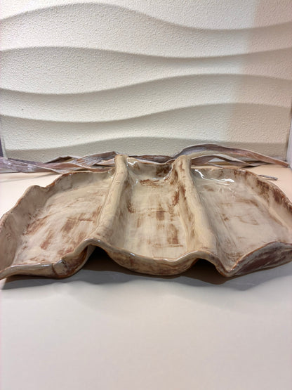 The Dune Wave Serving Platter draws inspiration from wind-swept sand patterns and the soft flow of natural forms. Handcrafted with three gentle ridges that create elegant sections, it’s perfect for presenting appetizers, cheeses, or desserts with effortless style. The warm, earthy glaze enhances its organic texture, making it both functional and visually captivating — a true centerpiece for any table.