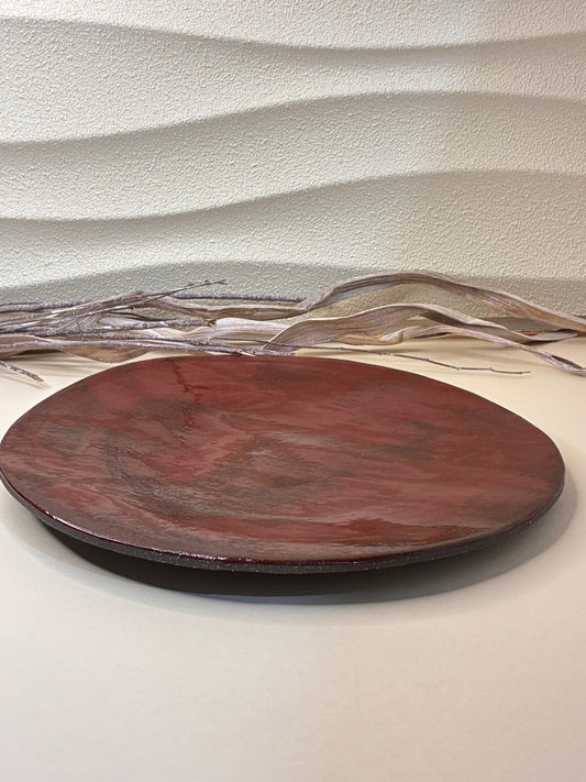 The Crimson Earth Dinner Plate brings a refined, handcrafted elegance to your dining table. Its deep red glaze and smooth, minimalist form highlight the natural warmth of clay, making it ideal for serving main courses or shared dishes. Each plate is individually shaped and glazed by hand, ensuring every piece is truly unique.