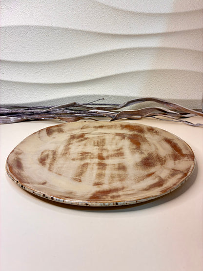 This handcrafted shallow ceramic plate features a blend of blue and light brown tones, creating a warm, earthy aesthetic with natural variation. Each plate is individually made by hand, resulting in a unique pattern and artisanal character. Designed exclusively for serving, it combines functionality with subtle, rustic elegance, adding a refined touch to any table setting.