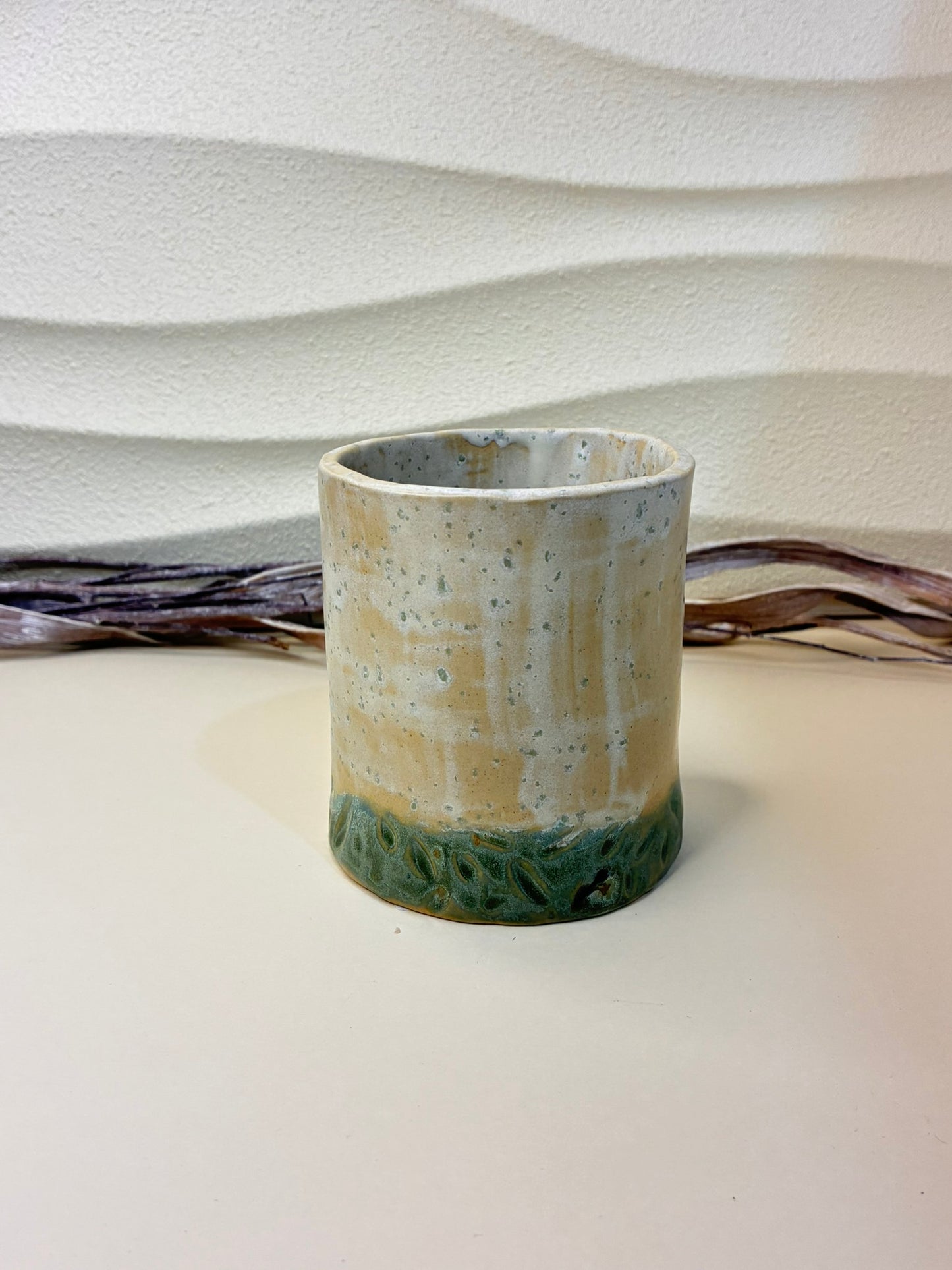 This handcrafted ceramic breadstick holder features a compact, vase-like form designed specifically for serving breadsticks or grissini. Part of a coordinated tableware set of plates and bowls, it complements the collection while adding vertical interest to the table. Each piece is carefully handmade, with subtle variations that highlight its artisanal character. 