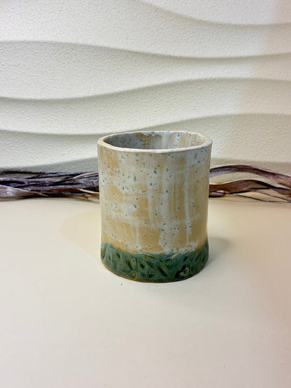 This handcrafted ceramic breadstick holder features a compact, vase-like form designed specifically for serving breadsticks or grissini. Part of a coordinated tableware set of plates and bowls, it complements the collection while adding vertical interest to the table. Each piece is carefully handmade, with subtle variations that highlight its artisanal character. 