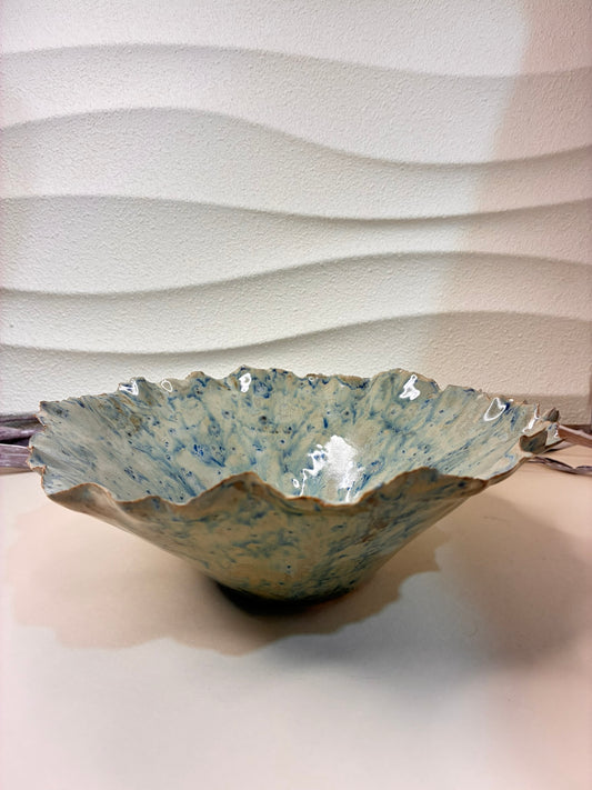 The Ocean Bloom Decorative Bowl evokes the gentle rhythm of sea waves and the natural elegance of blooming petals. Handcrafted with fluid, organic edges and glazed in soothing blue tones, it captures the essence of calm coastal beauty. Perfect as a centerpiece or accent piece, this bowl adds a serene and artistic touch to any space.