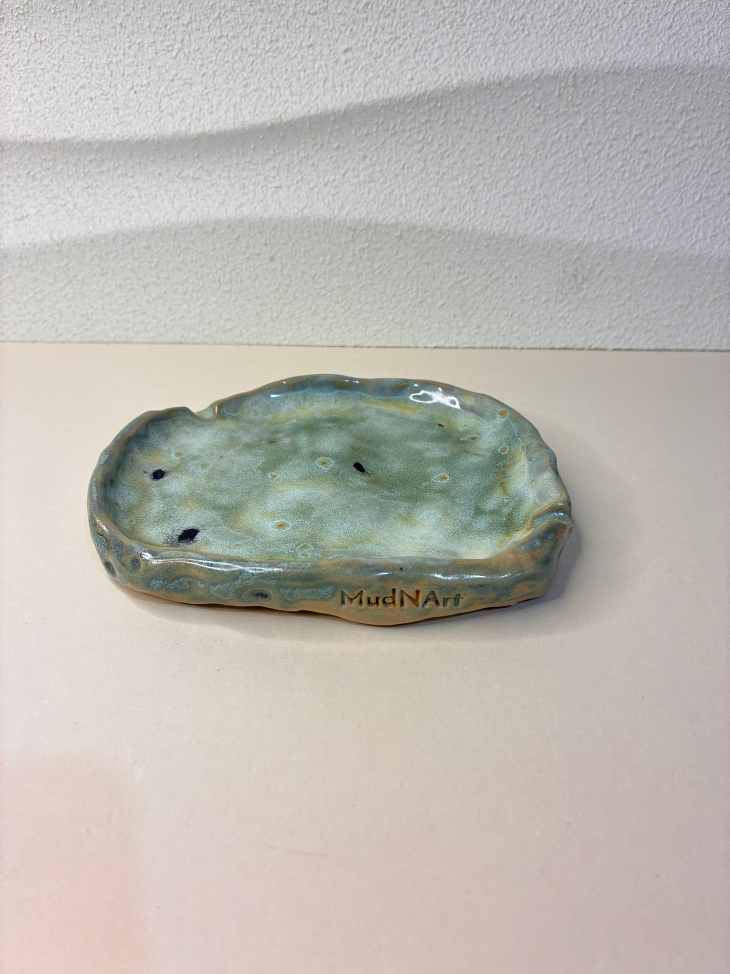 This handcrafted shallow tray serves as a discreet ashtray while also doubling as a jewelry holder. Its minimalist design and subtle, elegant form make it a versatile addition to any table, dresser, or shelf. Each piece is carefully handmade, with unique variations that highlight its artisanal character, combining functionality and refined style in one.