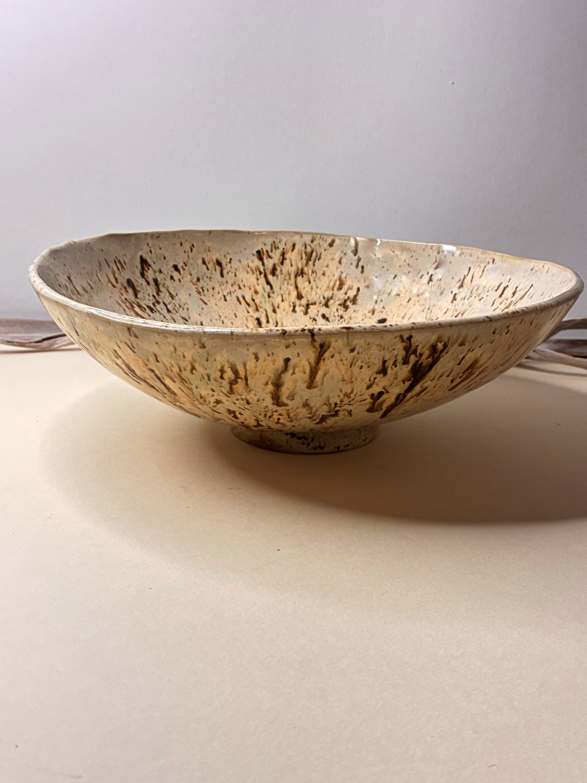 This handcrafted stoneware deep bowl combines natural beauty with everyday functionality. Carefully made by hand, each piece features subtle variations that highlight its artisanal character. Designed to be both decorative and functional, it is ideal for serving or displaying, bringing a warm, timeless touch to any space.