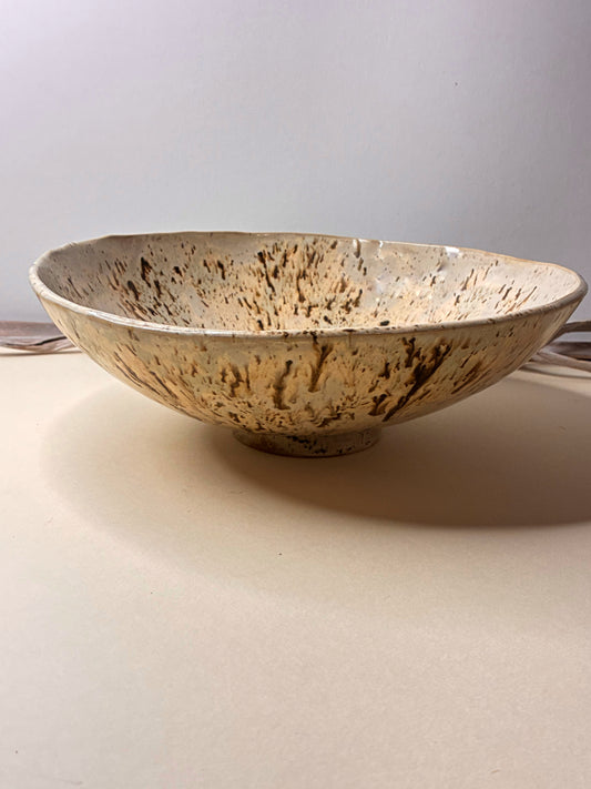 This handcrafted stoneware deep bowl combines natural beauty with everyday functionality. Carefully made by hand, each piece features subtle variations that highlight its artisanal character. Designed to be both decorative and functional, it is ideal for serving or displaying, bringing a warm, timeless touch to any space.