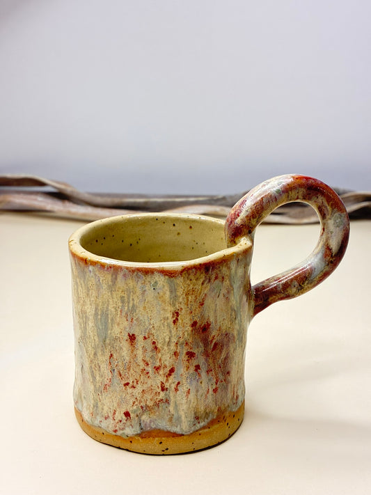 Sip in style with the Crimson Drift Mug, where soft white and smoky gray meet streaks of passionate red. Each mug is uniquely handmade, ensuring no two are alike, making every coffee or tea moment a work of art. Its smooth, tactile finish and bold yet harmonious colors bring warmth and personality to your daily ritual.